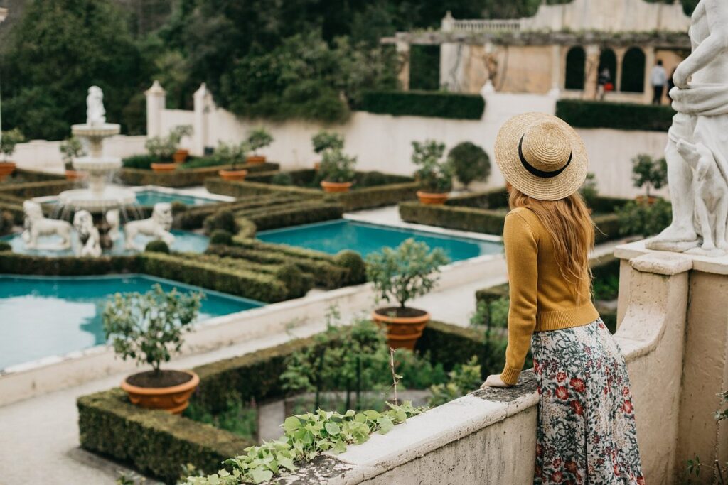 Woman in a hat admiring a Italian Renaissance-style garden