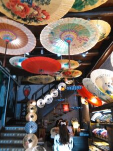 Shop with parasols hanging from the ceiling and parasols hanging from the stair banisters